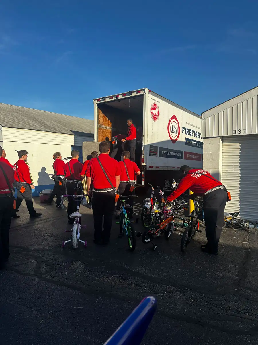 a team of Firefighters Move U in front of their truck